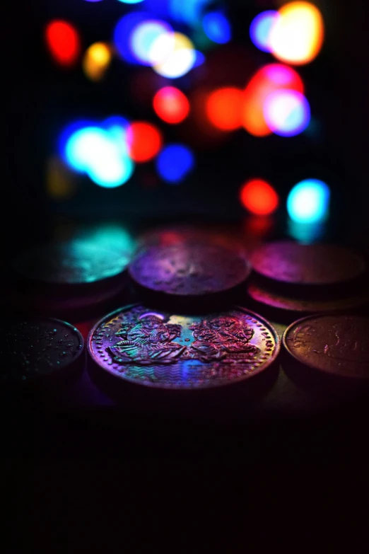 a bunch of lit up coins on a table