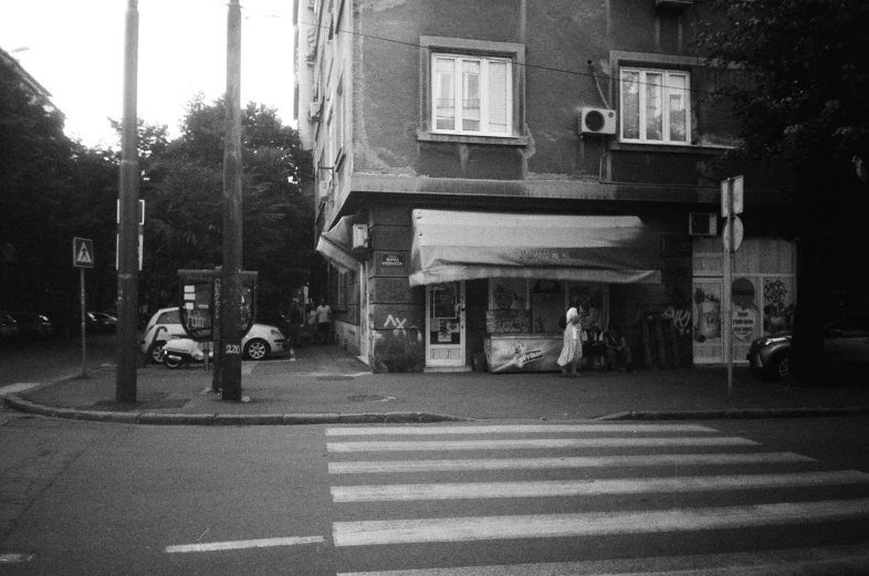 a black and white po of a building and a cross walk