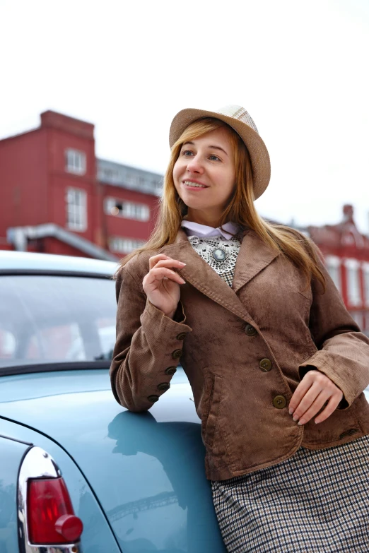 a woman leaning on the trunk of a car