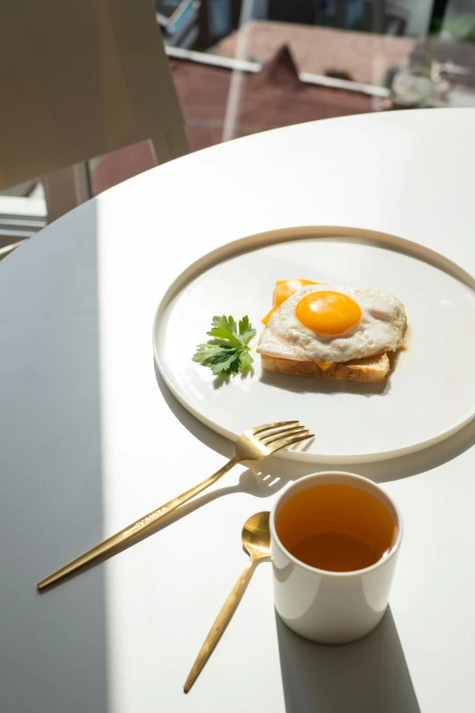 an egg and toast with a small cup of tea