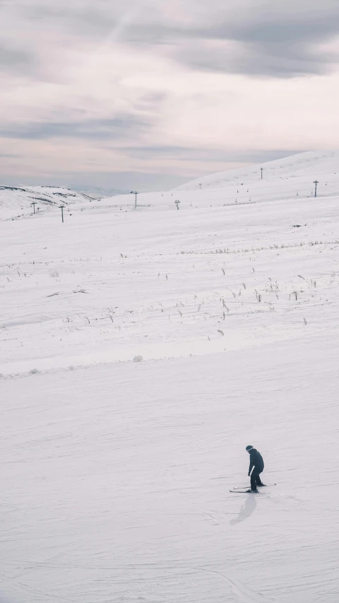 a man standing on top of a snow covered slope