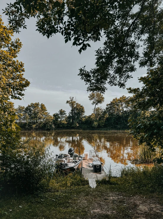 a small boat tied up on a lake shore