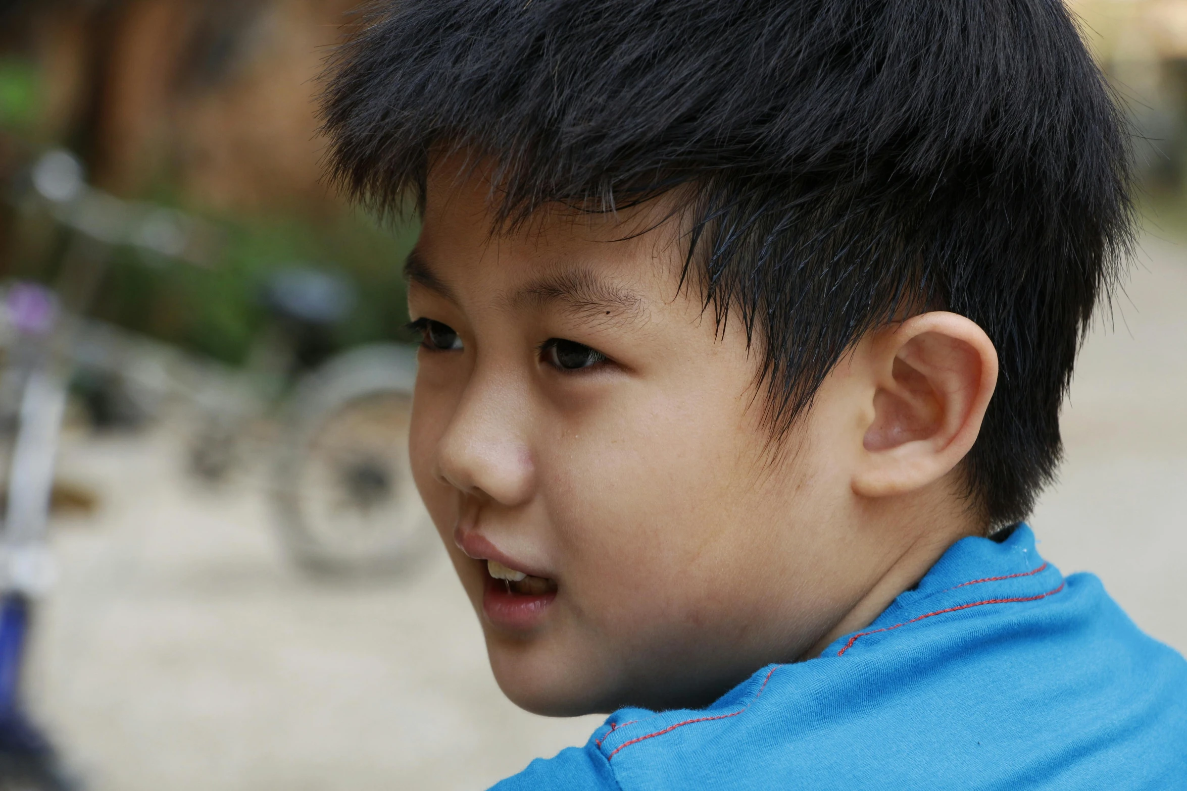 a young asian boy with a short black hair