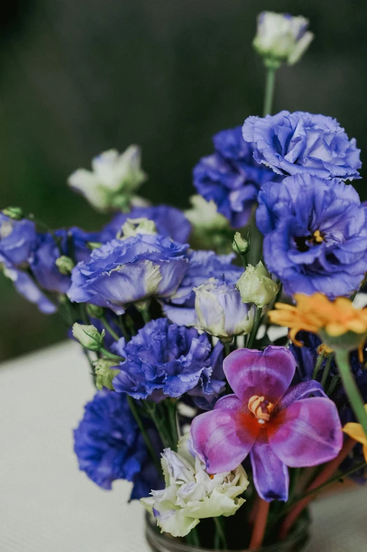 an assortment of flowers in a clear vase