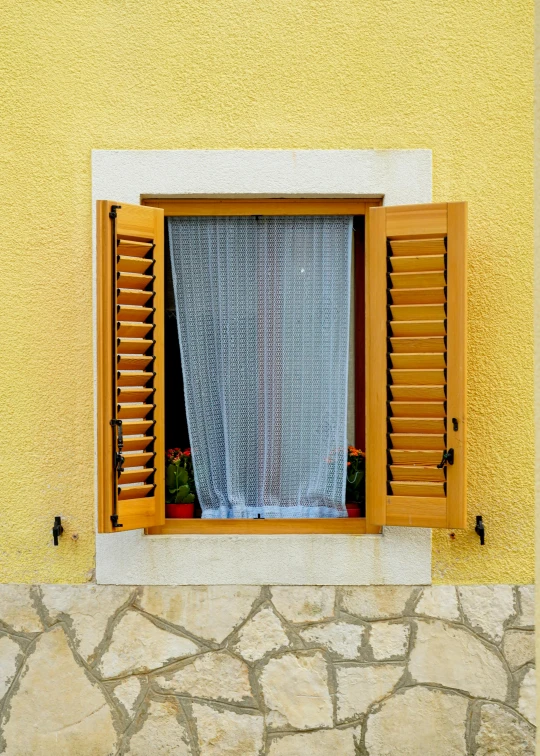 an open window with a curtain in the middle