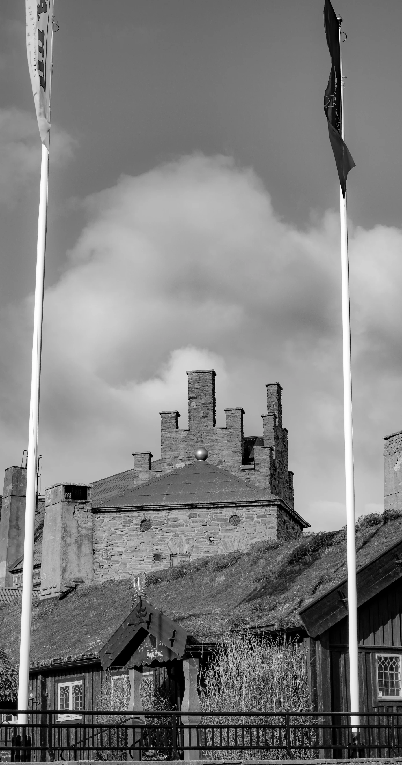 a street post and sign outside of a castle