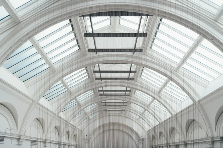 a ceiling with chandeliers and people on it