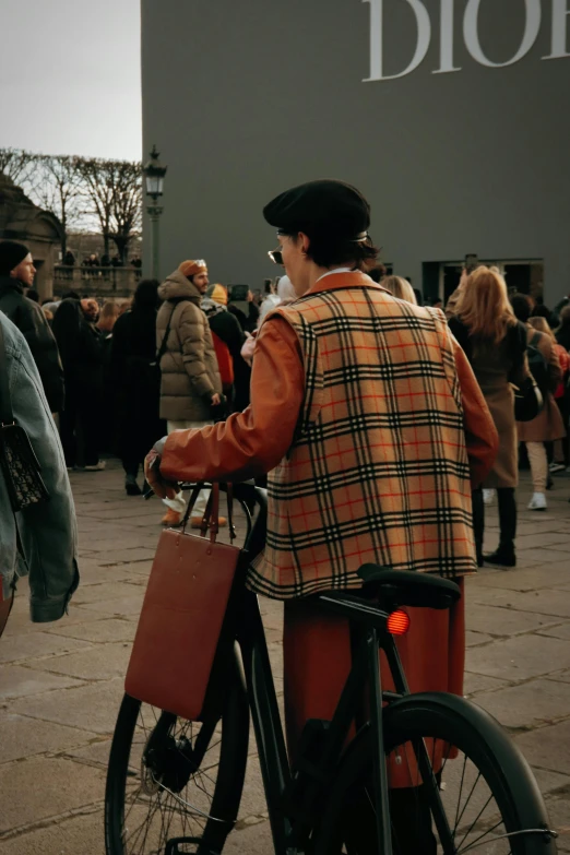 a man riding his bike outside wearing a burber outfit