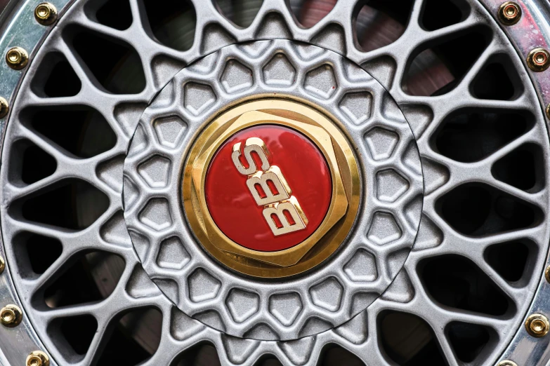 a red tire is painted gold with a monogram design