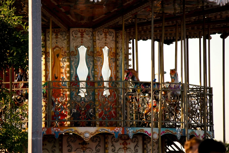 people on a carousel looking out the balcony