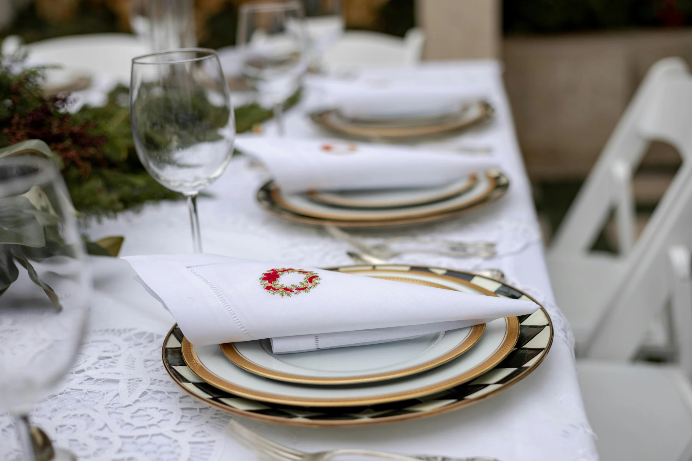 a table that has plates, napkins and glasses on it