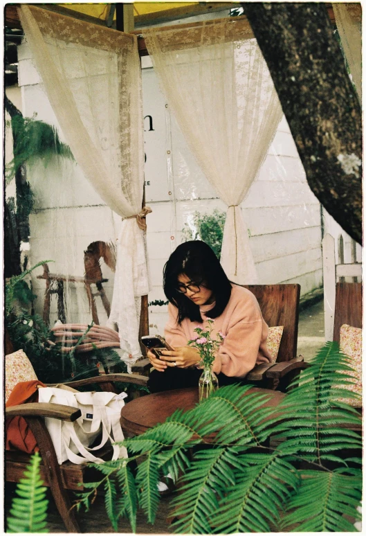 a woman sitting on the ground holding a phone