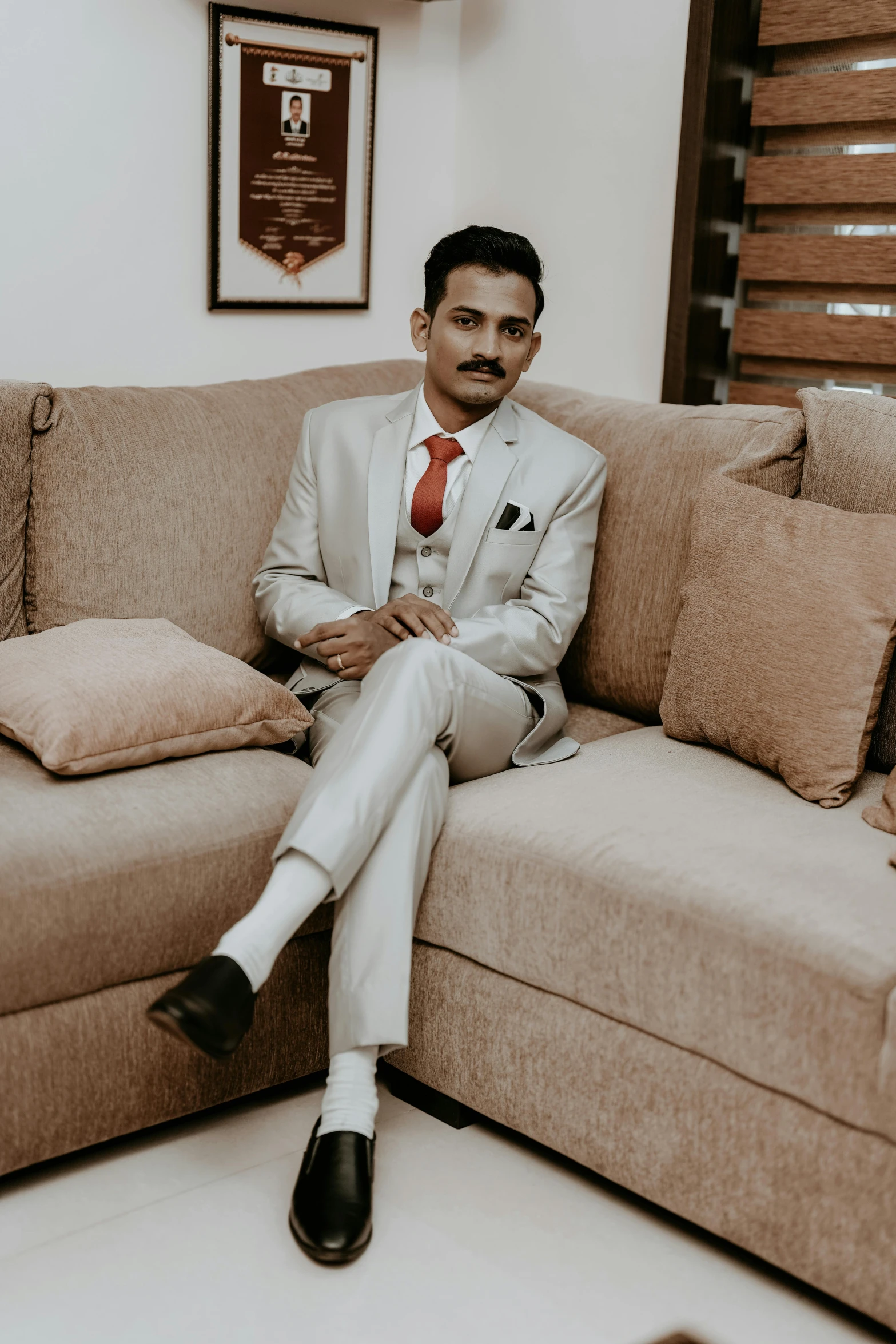 a man sitting on a couch in a living room