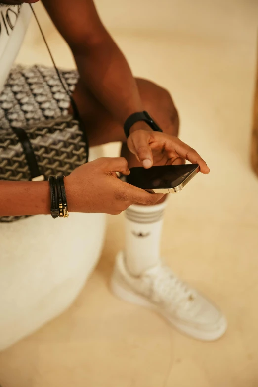 a woman sitting down with her cellphone