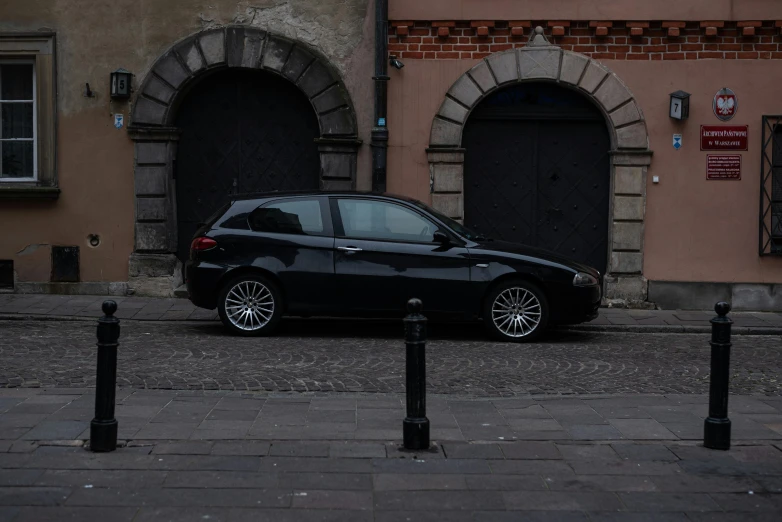 a car parked in the street next to a building