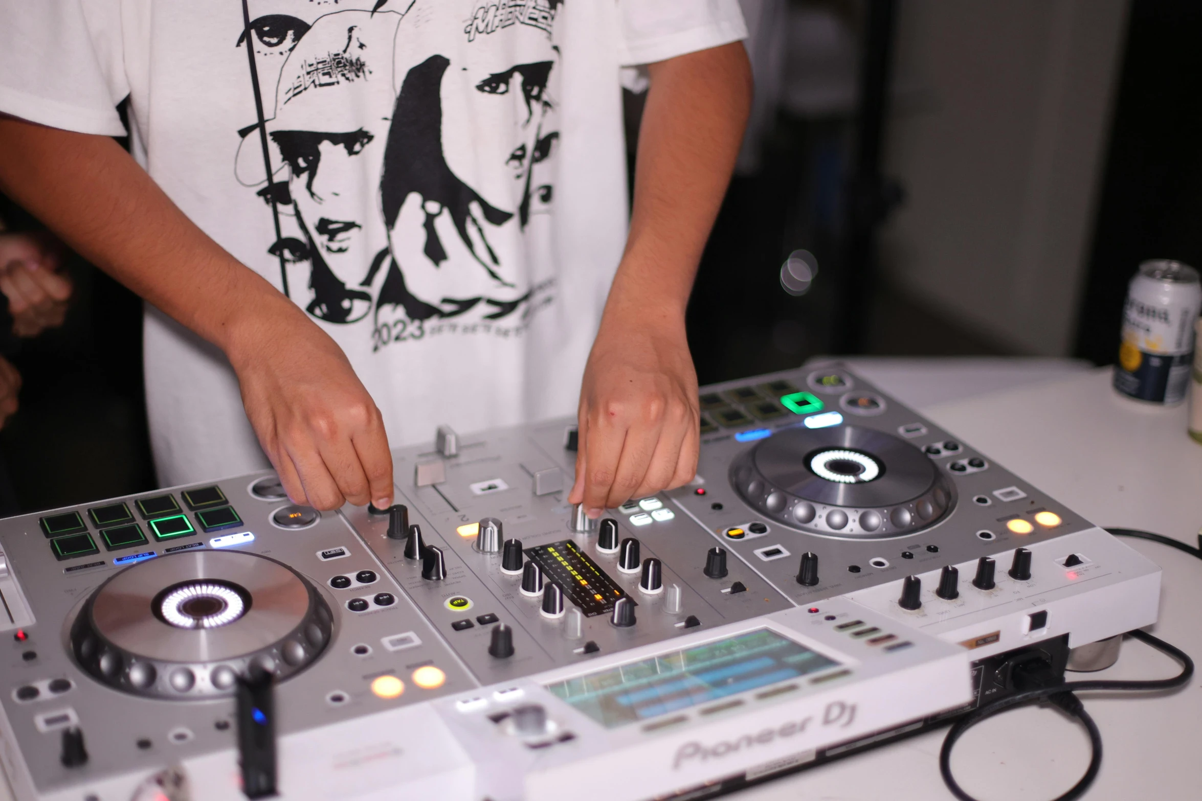 man in white shirt holding a deckset at a party