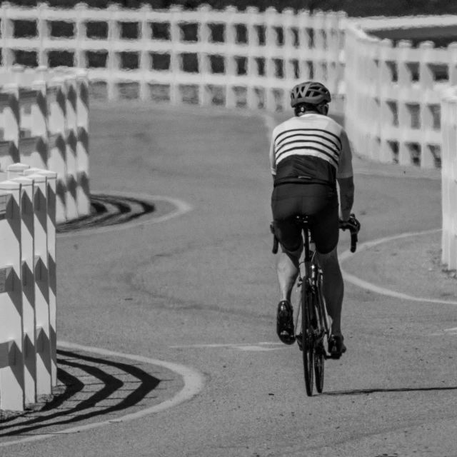 the man is riding his bike on the road