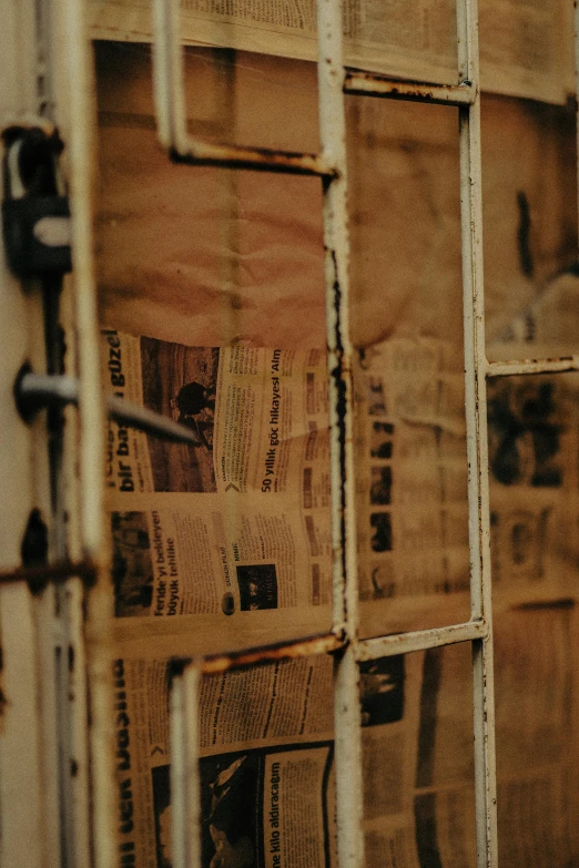 an old window with newspaper paper taped in it