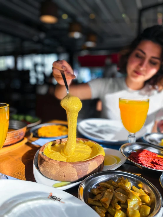 a woman is putting sauce on some food