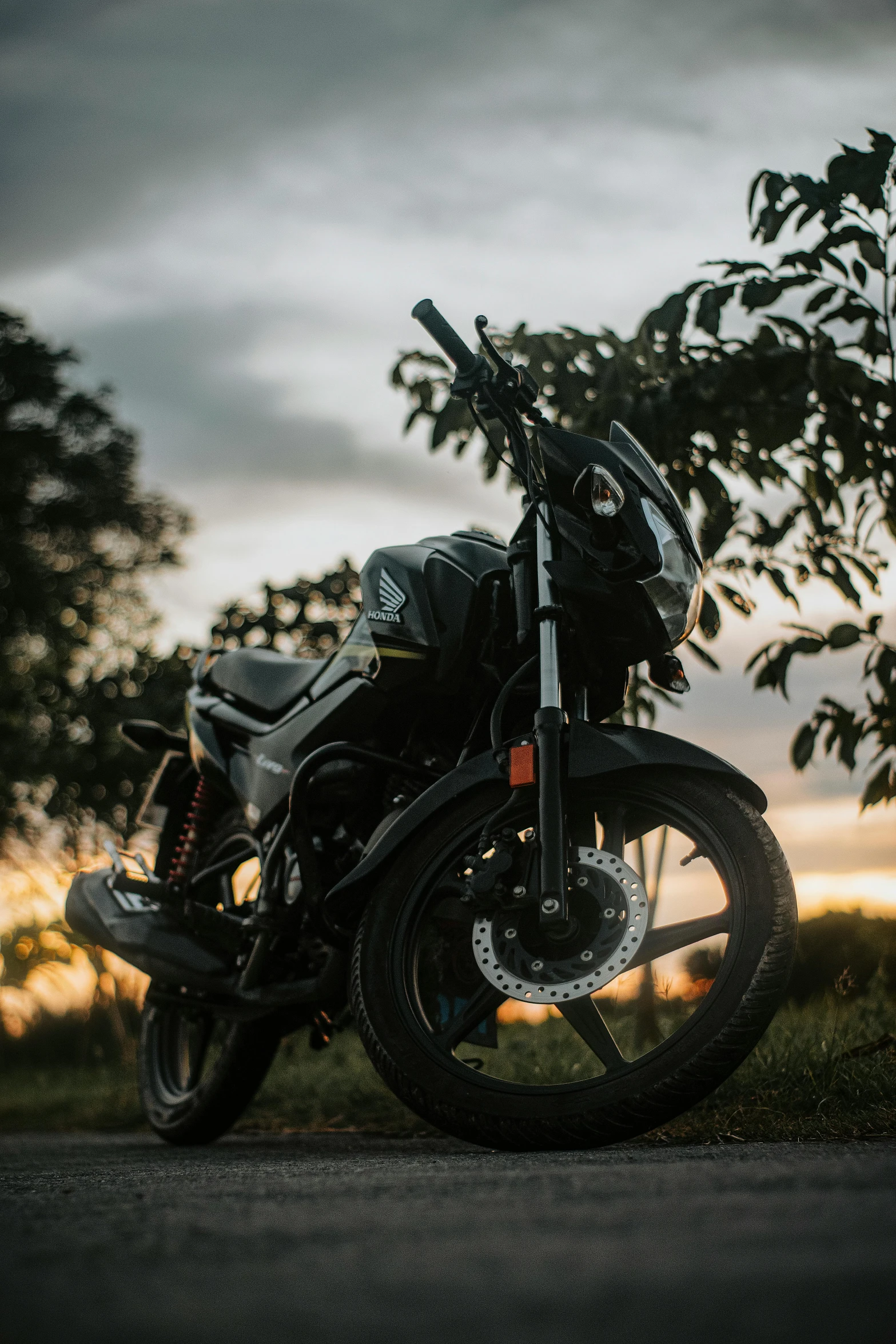 a motorcycle parked in the middle of a dirt road