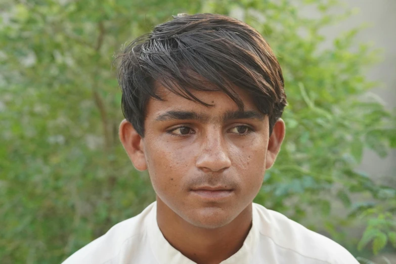 a young man is in his dress shirt looking into the camera