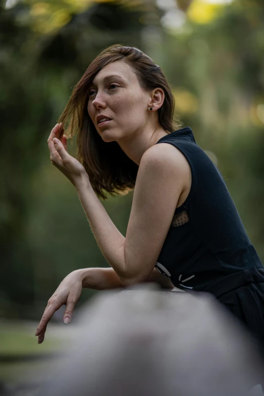 woman with hand on her hair sitting down