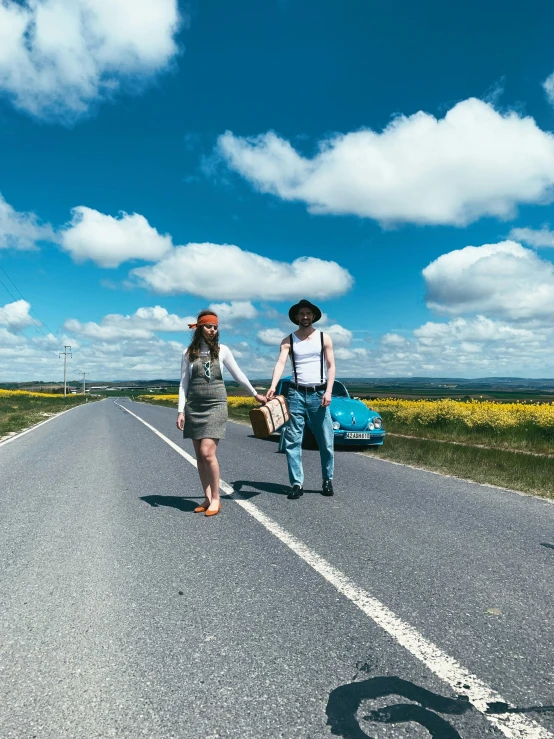 a young couple walks hand in hand on the highway