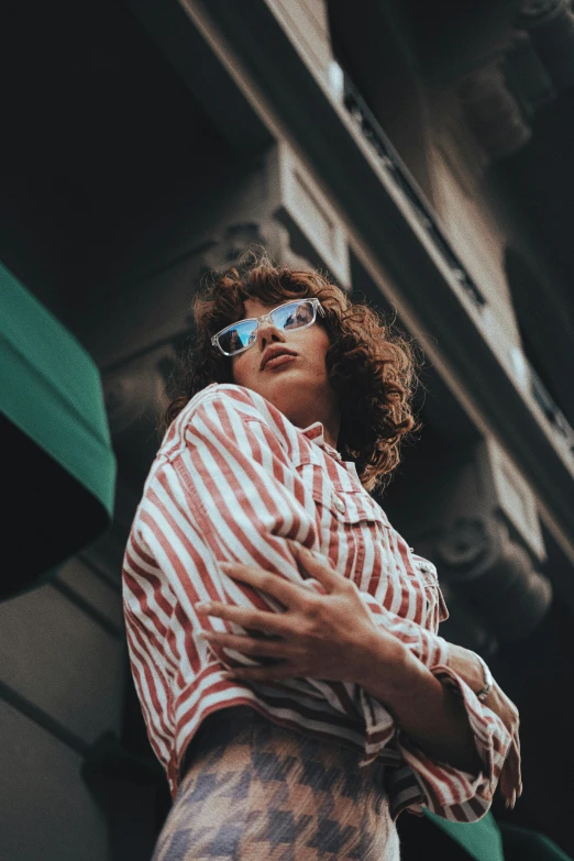 a woman wearing shades and a striped shirt