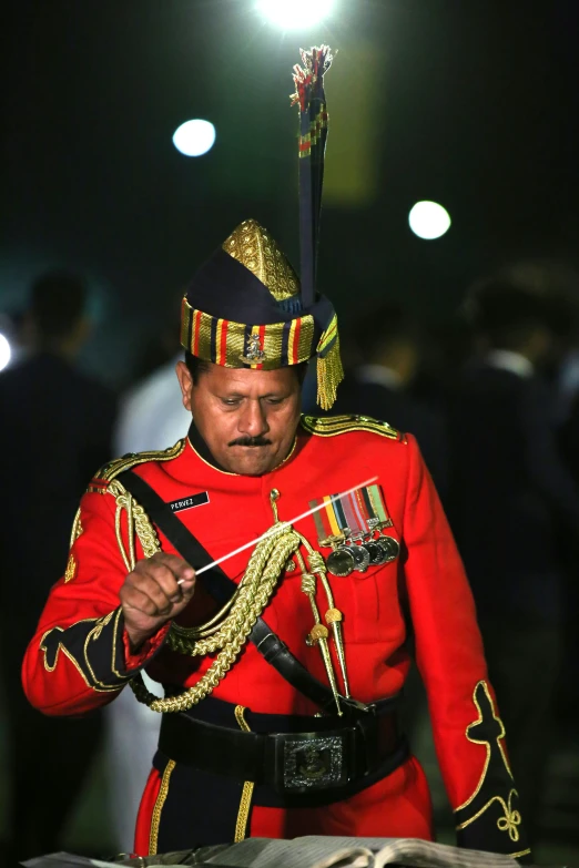 a man in uniform, holding an arrow