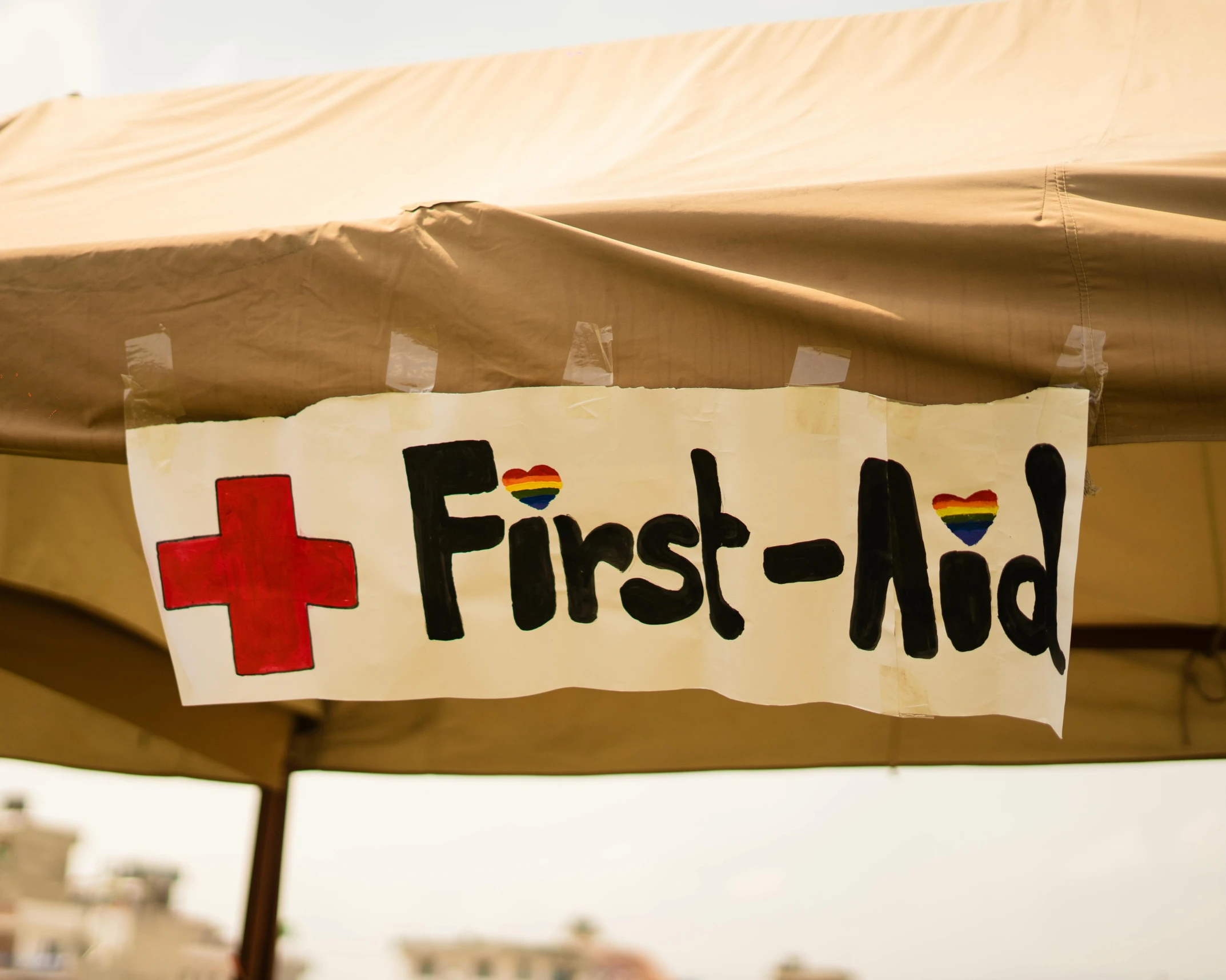 signs with the words first aid and a cross