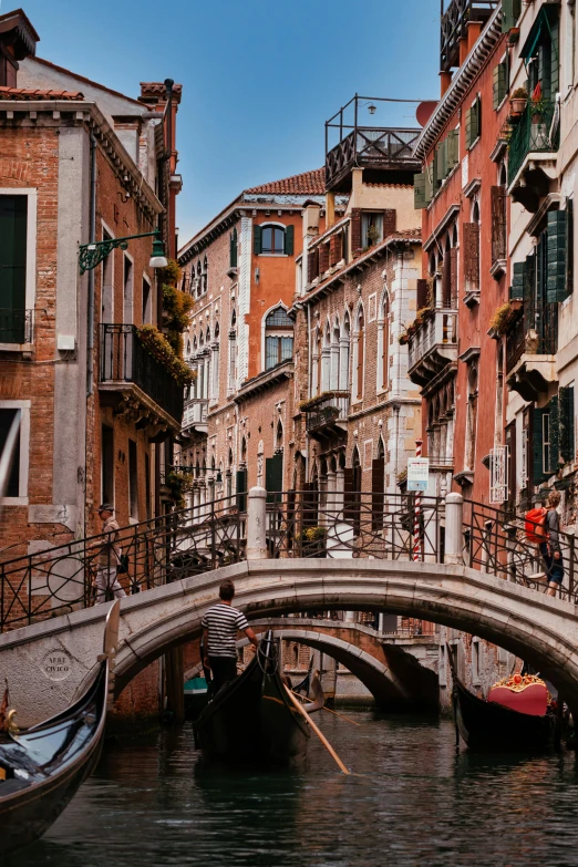 a narrow canal with lots of water and a boat going under it