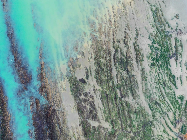 an image of aerial view of beach sand and water