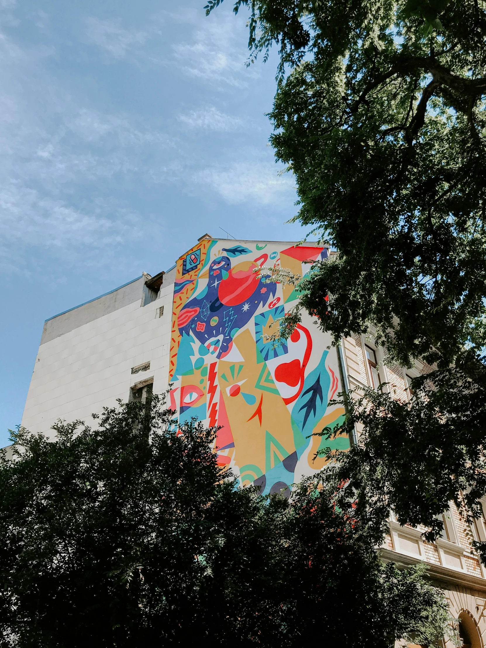 a tall building with a colorful mural on the side