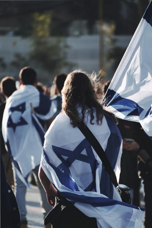 people in the street with flags and banners