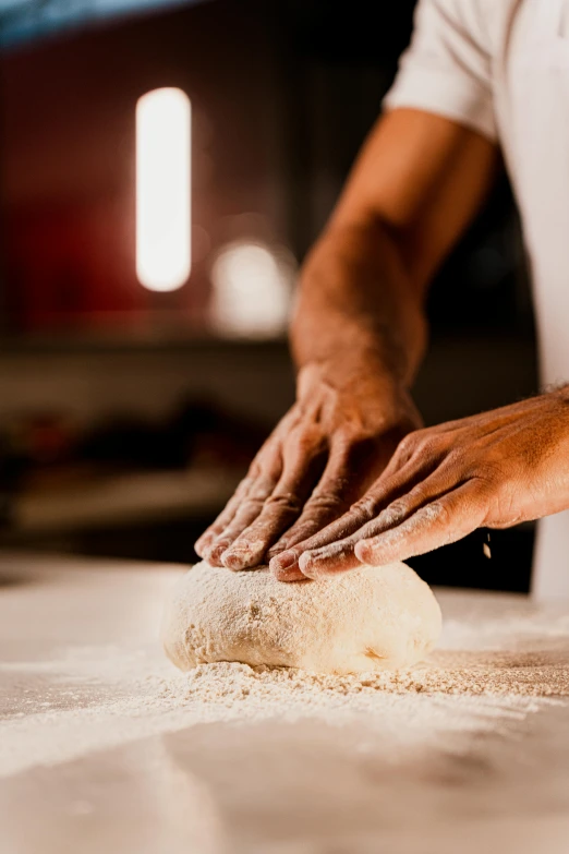 a person that is kneading some kind of kneader