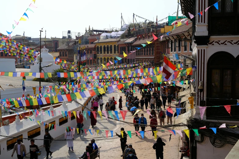 many people on the street below lots of flags