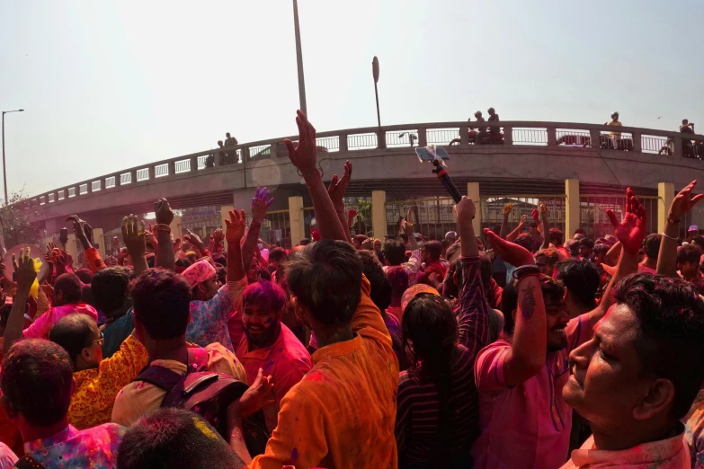 a bunch of people celeting colors in the street