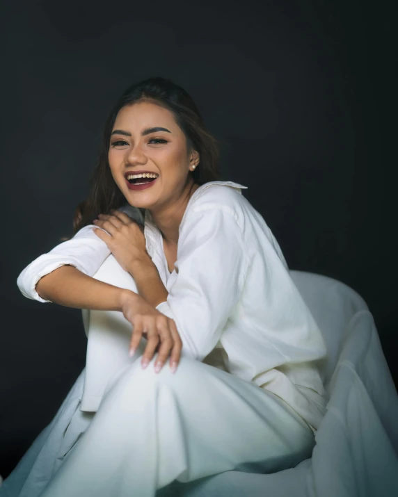 the young woman is posing for the camera wearing white