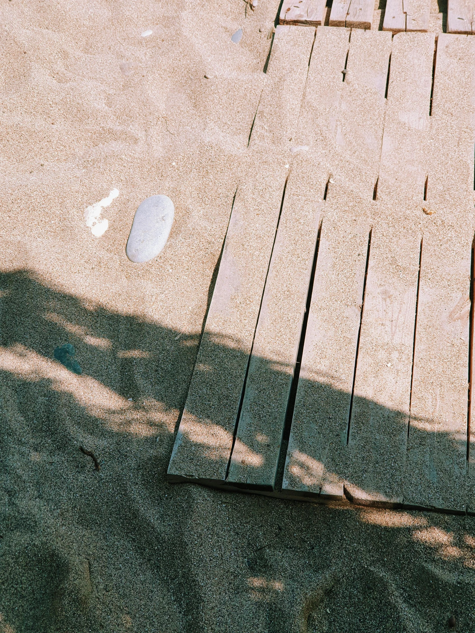 a shadow of people in front of a sidewalk