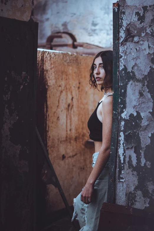 a woman with no shoes is standing in a rundown house