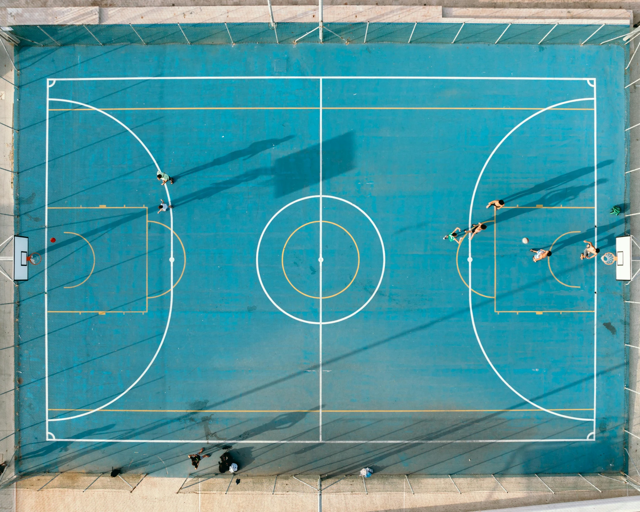 overhead s of a basketball court with a number of people playing