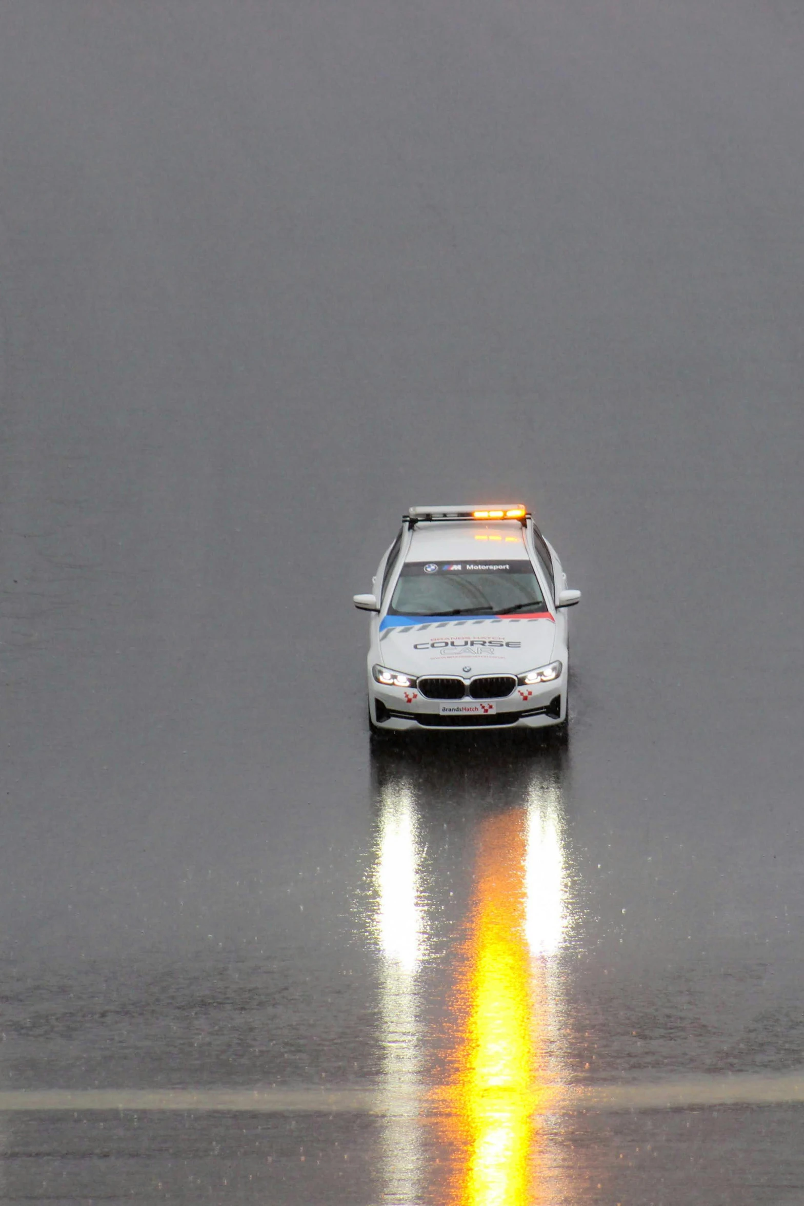 the police car is traveling through the rain