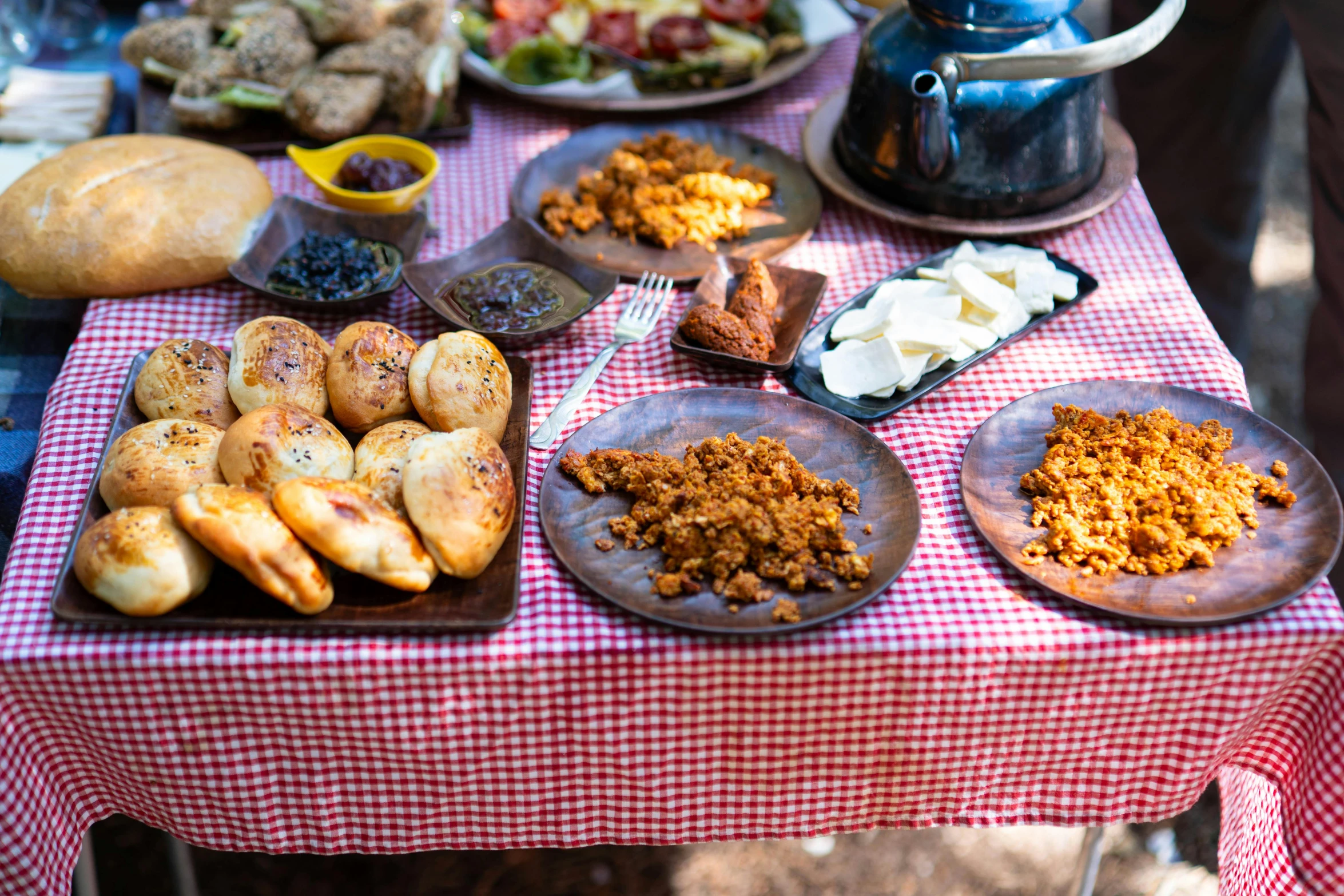 plates full of food sit on a picnic table