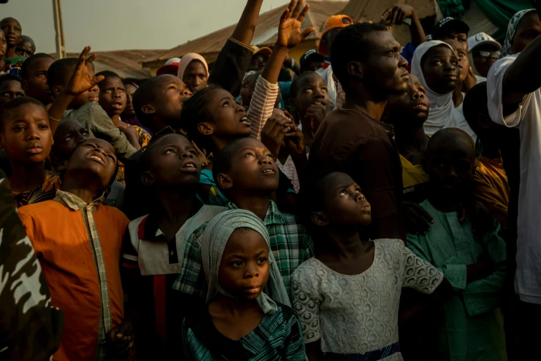 a crowd of people watching soing while they are in the street