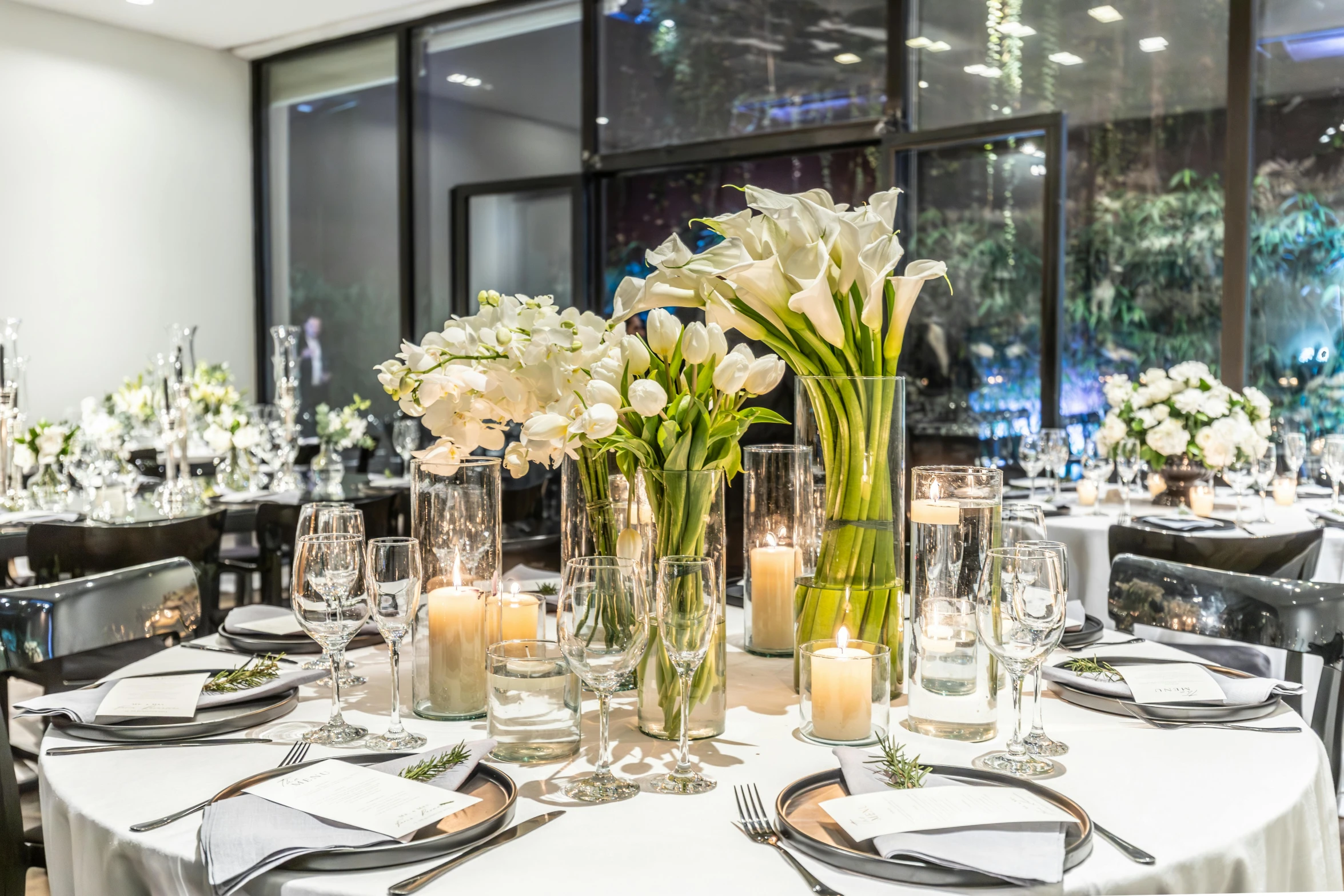 an indoor dining room table decorated for a reception