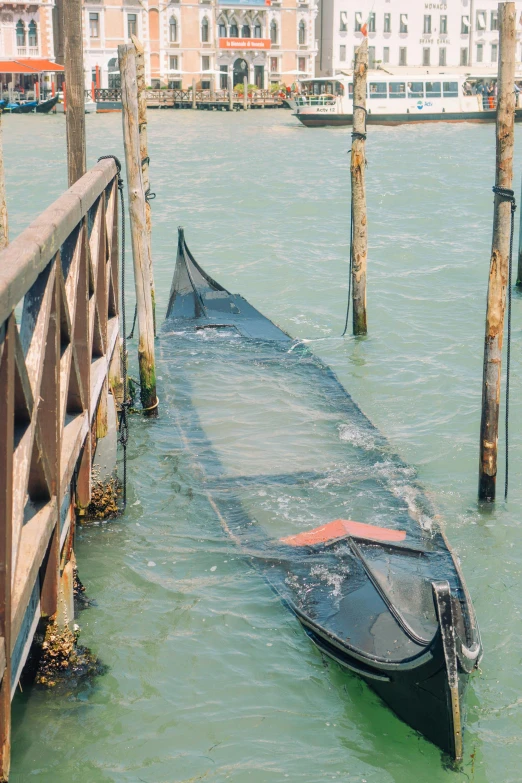 there is a row boat on the water next to the pier