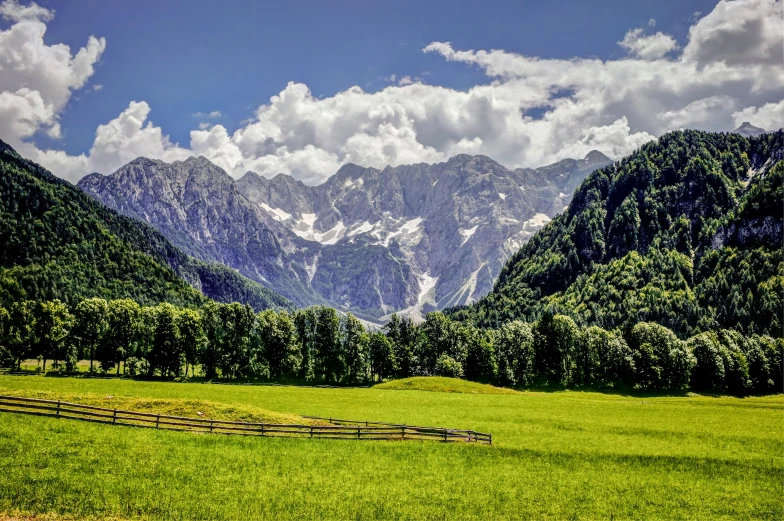 the mountains are covered with cloud filled sky