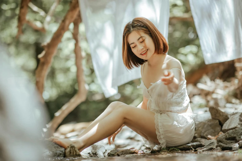 a woman sitting on the ground under an awning