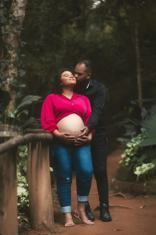 a young pregnant couple emcing during their engagement session