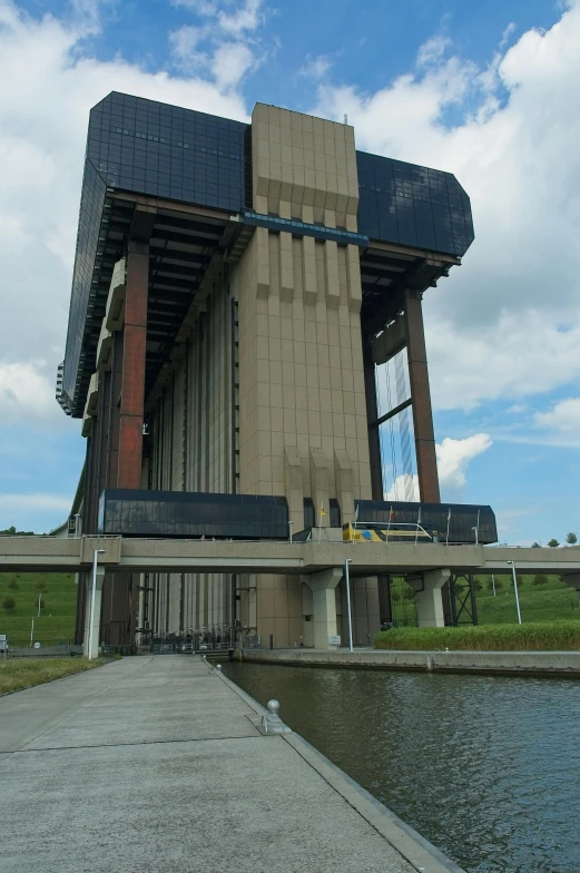 a tall building with a large structure near the water